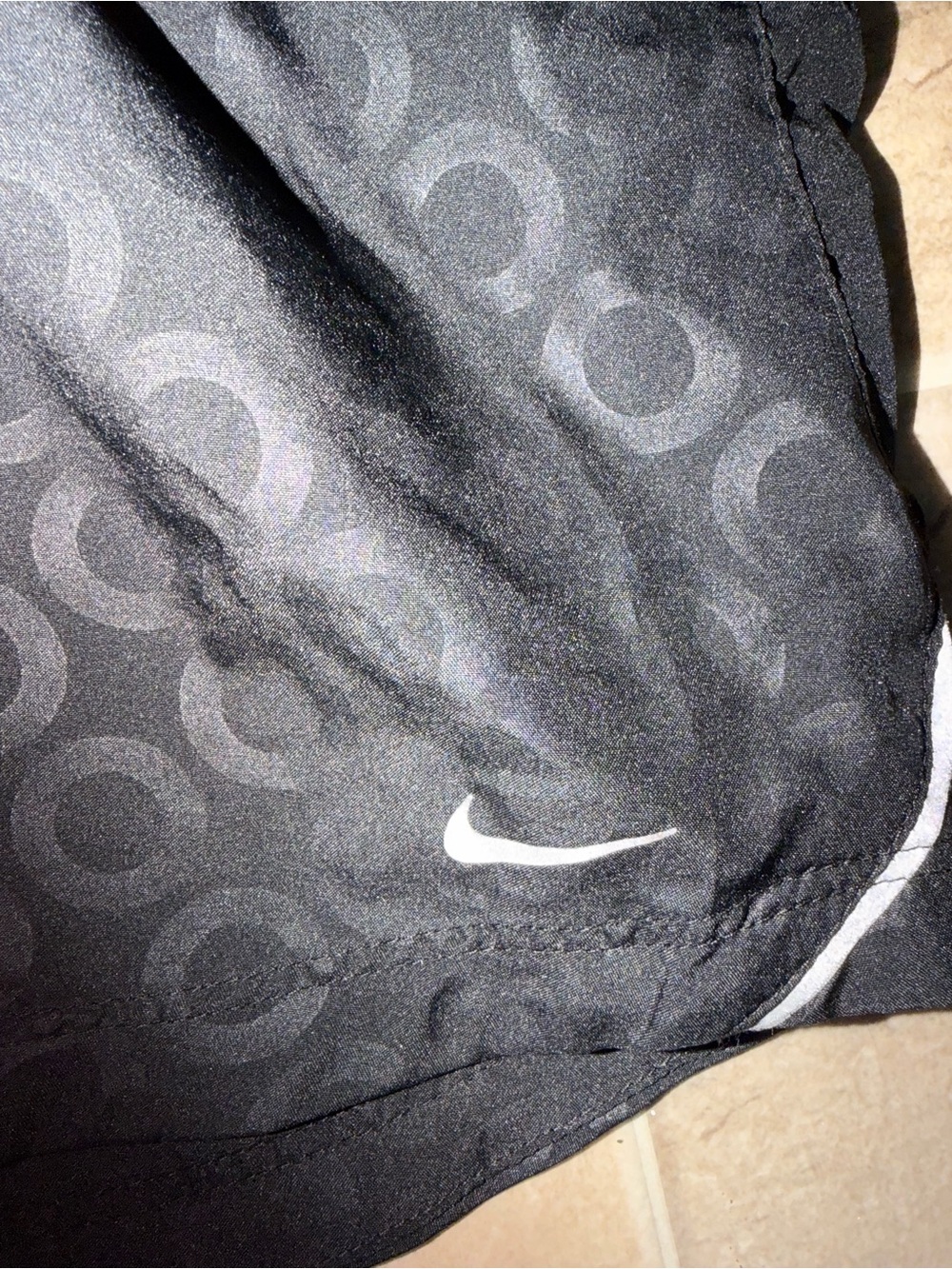 Nike Black Athletic Shorts with Subtle Circle Pattern and White Swoosh